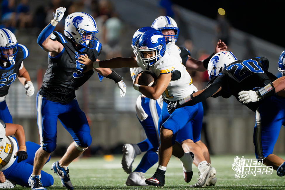Omaha North's Dominic Yancy carries the ball during a Vikings football game